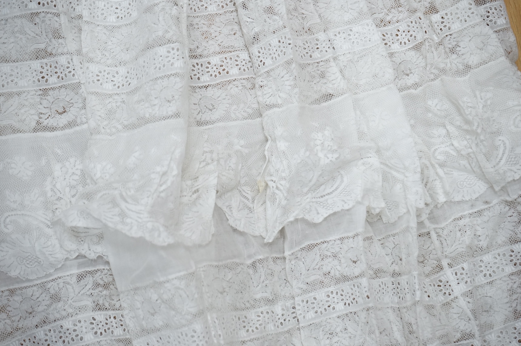 A collection Victorian textiles to include a lace christening gown, Irish crochet and a net baby gown